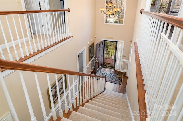 foyer entrance featuring wood-type flooring and a chandelier