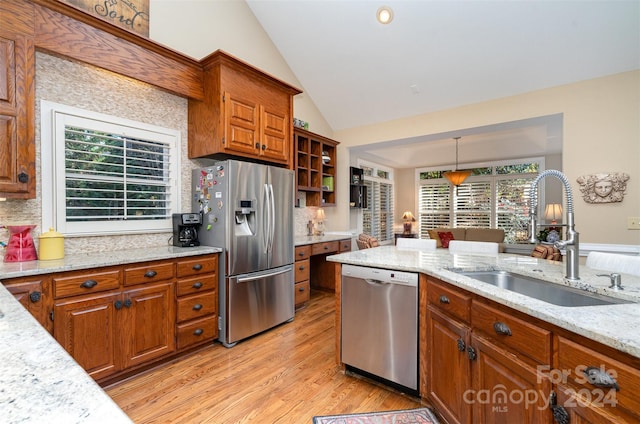 kitchen featuring appliances with stainless steel finishes, light wood-type flooring, plenty of natural light, and sink