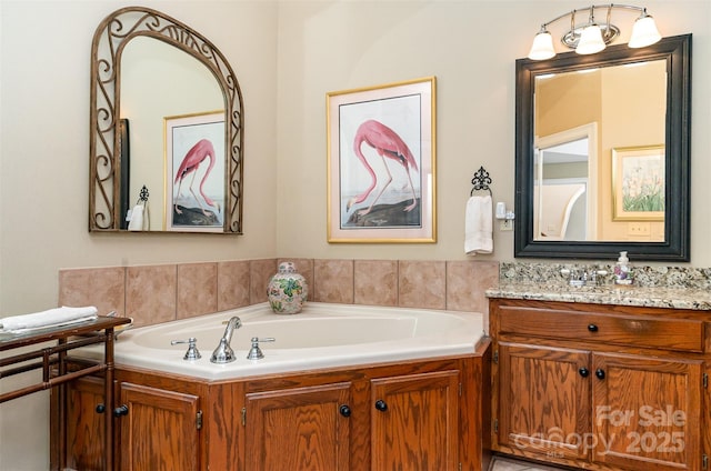 full bathroom with a bath and vanity
