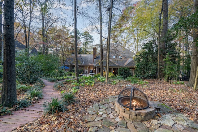 view of yard featuring an outdoor fire pit and a patio area