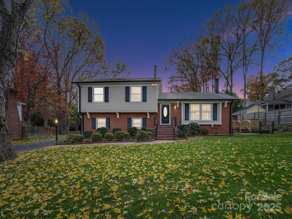 tri-level home featuring a yard