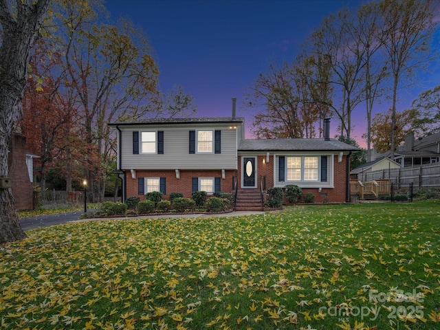 tri-level home featuring a yard