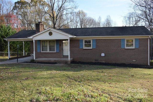 ranch-style home with a front yard and a carport