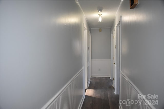 hall with dark hardwood / wood-style floors and ornamental molding