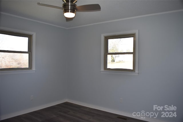 spare room featuring ceiling fan, dark hardwood / wood-style flooring, and crown molding