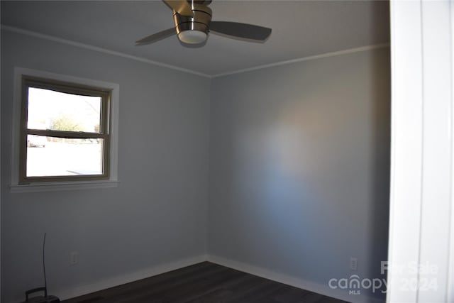 unfurnished room featuring ceiling fan, crown molding, and dark wood-type flooring