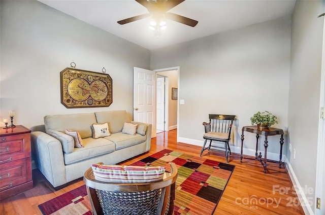 living room featuring ceiling fan and hardwood / wood-style floors