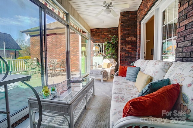 sunroom featuring ceiling fan