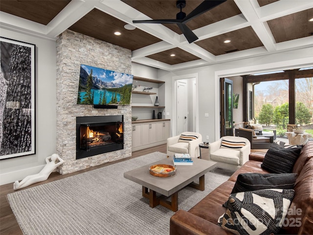 9 Haverhill Way, Arden, NC 28704 - living area with coffered ceiling, a ceiling fan, a stone fireplace, wood finished floors, and beam ceiling