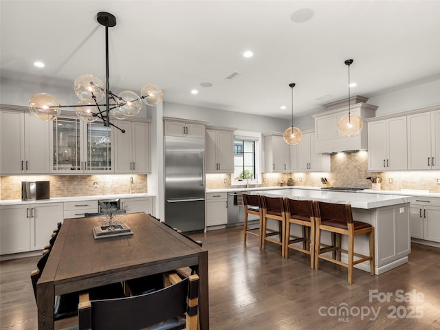 9 Haverhill Way, Arden, NC 28704 - kitchen featuring stainless steel appliances, tasteful backsplash, a breakfast bar, a chandelier, and light countertops