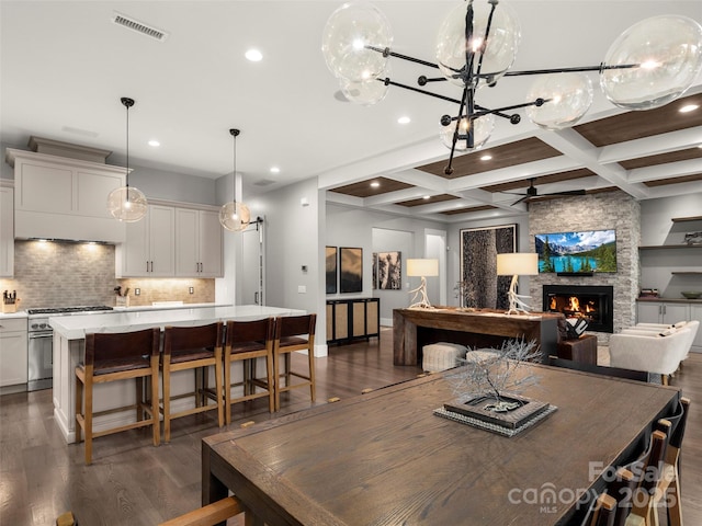 9 Haverhill Way, Arden, NC 28704 - dining space with a fireplace, dark wood finished floors, recessed lighting, beam ceiling, and coffered ceiling