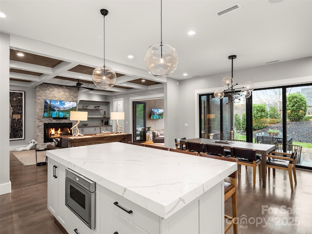 9 Haverhill Way, Arden, NC 28704 - kitchen featuring stainless steel microwave, dark wood-type flooring, white cabinetry, recessed lighting, and coffered ceiling