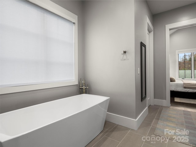 9 Haverhill Way, Arden, NC 28704 - ensuite bathroom featuring a freestanding tub, baseboards, and tile patterned flooring