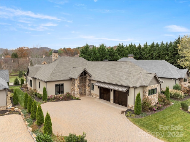 9 Haverhill Way, Arden, NC 28704 - mid-century home with stone siding, a garage, a chimney, stucco siding, and decorative driveway