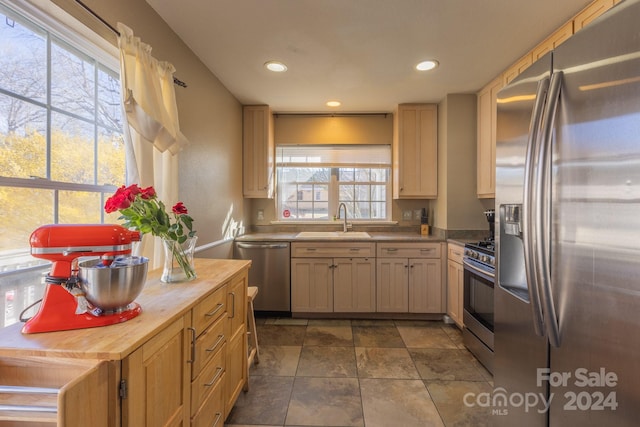 kitchen with light brown cabinetry, sink, appliances with stainless steel finishes, and wooden counters