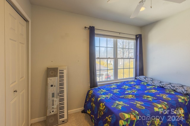 bedroom with carpet, a closet, and ceiling fan