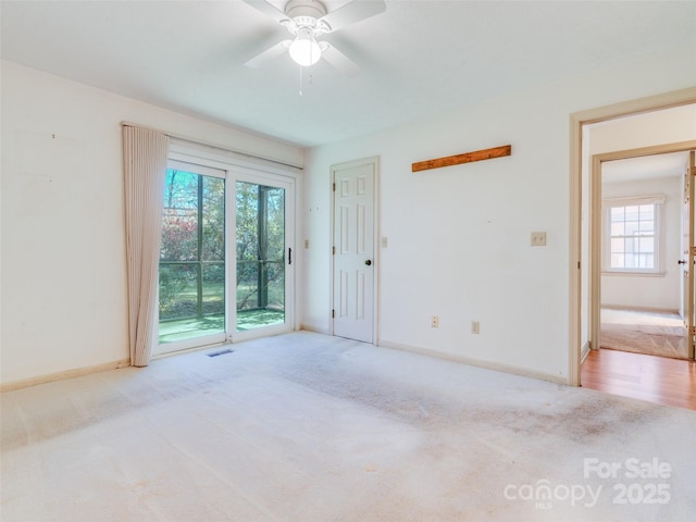 carpeted spare room with ceiling fan and a healthy amount of sunlight