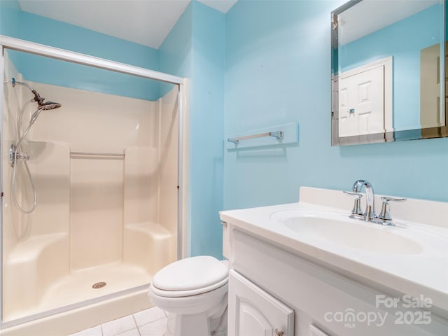 bathroom with tile patterned flooring, toilet, a shower, and vanity