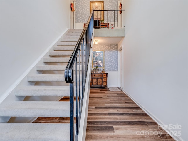 staircase with wood-type flooring