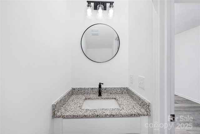 bathroom featuring vanity and hardwood / wood-style floors