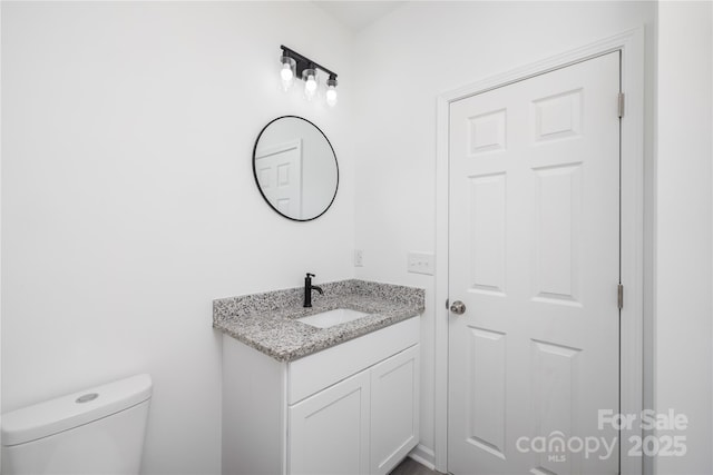 bathroom featuring vanity and toilet