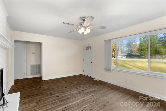 unfurnished living room with a fireplace, dark hardwood / wood-style flooring, ceiling fan, and crown molding