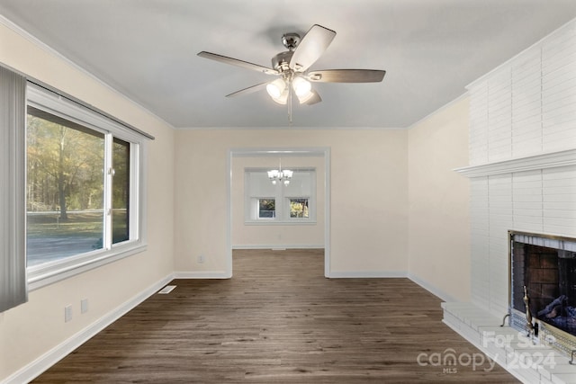 unfurnished living room with a fireplace, dark hardwood / wood-style flooring, and ceiling fan with notable chandelier