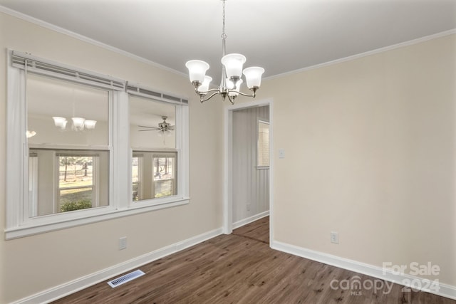 unfurnished dining area with crown molding, dark hardwood / wood-style flooring, and ceiling fan with notable chandelier