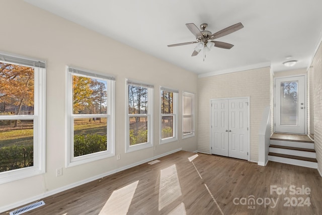 unfurnished bedroom with dark hardwood / wood-style flooring, a closet, and ceiling fan