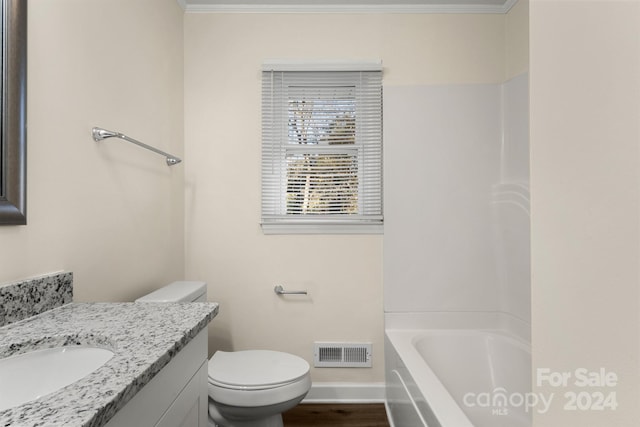 bathroom featuring vanity, ornamental molding, and toilet