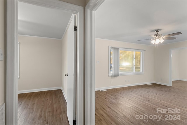 corridor featuring light hardwood / wood-style flooring and ornamental molding