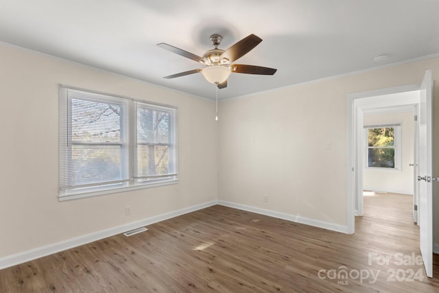 spare room featuring hardwood / wood-style flooring, ceiling fan, and ornamental molding