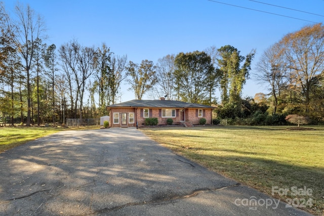 ranch-style house with a front lawn