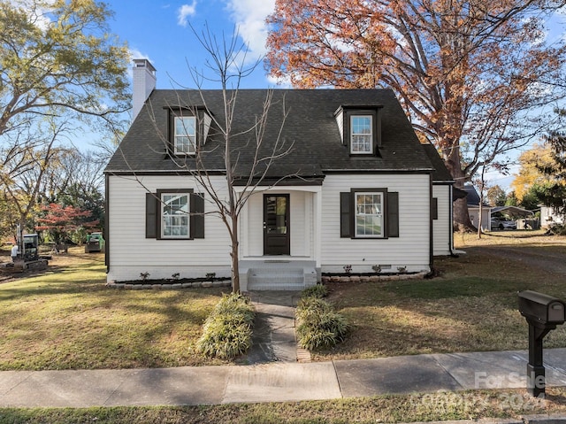 cape cod home featuring a front lawn