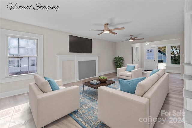 living room with ceiling fan and light hardwood / wood-style floors