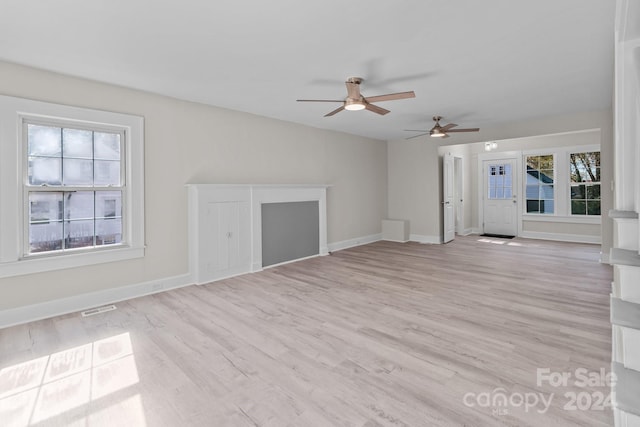 unfurnished living room with ceiling fan and light hardwood / wood-style floors