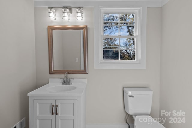 bathroom featuring vanity and toilet