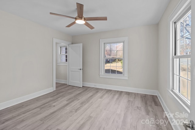 spare room featuring light hardwood / wood-style floors and ceiling fan