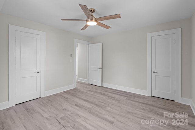 unfurnished bedroom with light wood-type flooring and ceiling fan