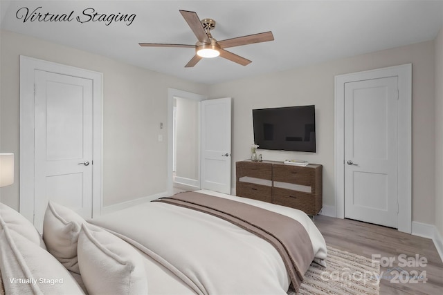 bedroom with light hardwood / wood-style flooring and ceiling fan