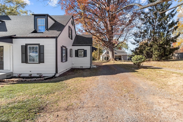 view of side of home with a lawn