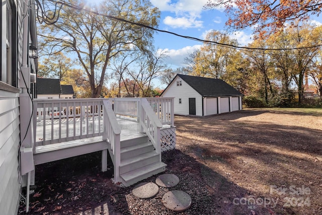 wooden deck with a garage and an outdoor structure