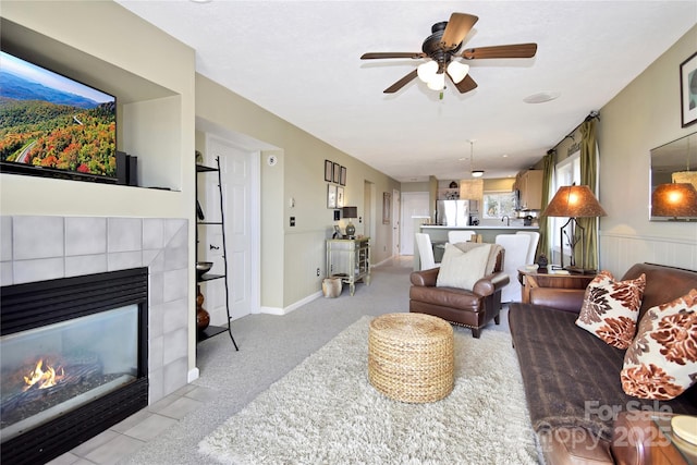 510 Elderberry Ridge Rd Unit E101, Banner Elk, NC 28604 - living room featuring a tiled fireplace, ceiling fan, carpet flooring, and wainscoting