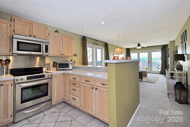 510 Elderberry Ridge Rd Unit E101, Banner Elk, NC 28604 - kitchen featuring stainless steel appliances, light brown cabinets, a peninsula, light countertops, and a ceiling fan
