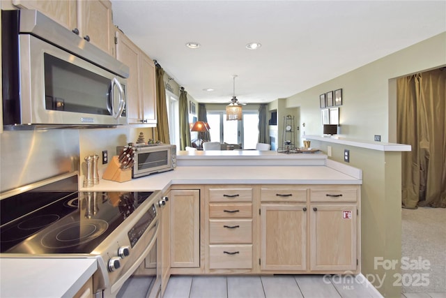 510 Elderberry Ridge Rd Unit E101, Banner Elk, NC 28604 - kitchen with appliances with stainless steel finishes, light brown cabinetry, light countertops, a peninsula, and recessed lighting