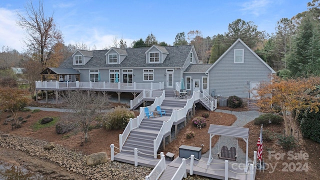 rear view of property with cooling unit and a deck