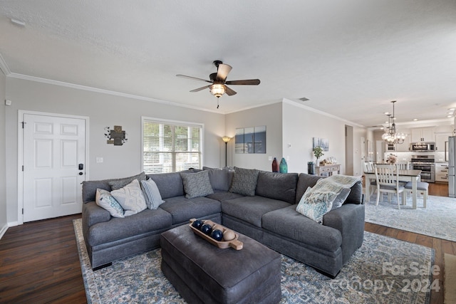 living room featuring dark hardwood / wood-style floors, ornamental molding, and ceiling fan with notable chandelier