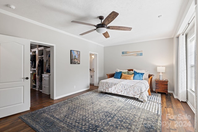 bedroom featuring ceiling fan, dark hardwood / wood-style floors, a textured ceiling, and a closet