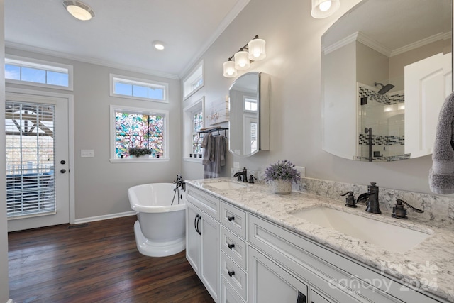 bathroom with hardwood / wood-style floors, vanity, ornamental molding, and shower with separate bathtub