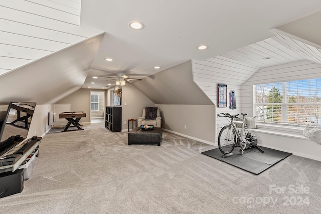 exercise area with ceiling fan, lofted ceiling, and light carpet